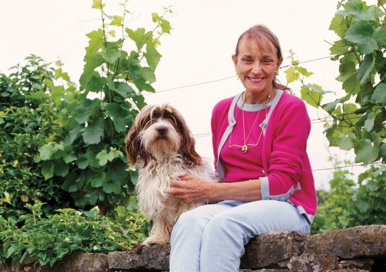 Lalou Bize-Leroy (and Basil) on the wall at the top   of her parcel of the Grand Cru Richebourg vineyard.   Vosne-Romanée, Côte d'Or, France. [Côte de Nuits]