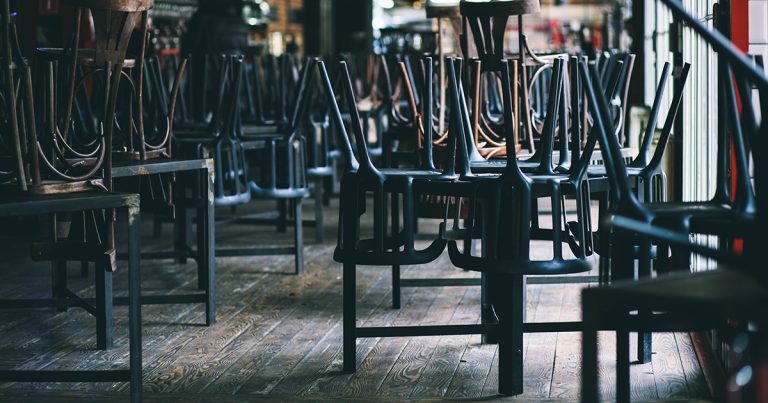 Chairs and tables stacked in a closed pub