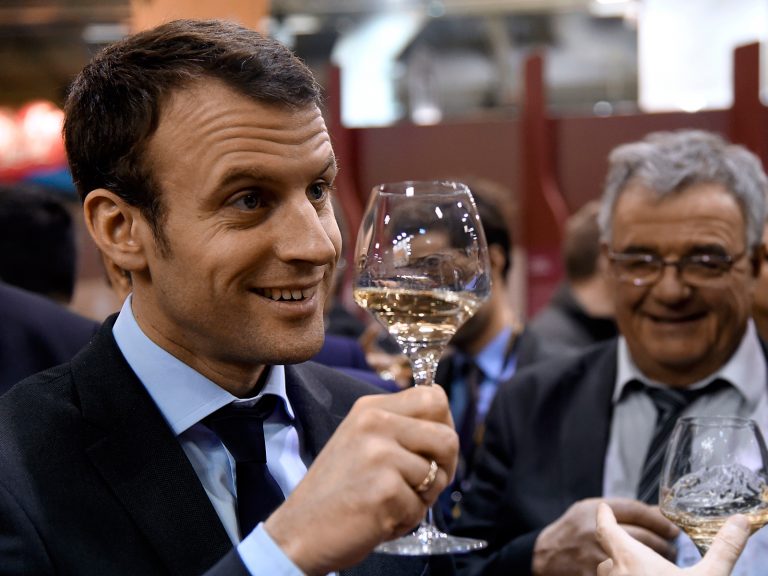 French Economy and Industry minister Emmanuel Macron tastes wine as he visits the Salon de l'Agriculture farm fair on March 3, 2016 in Paris. / AFP PHOTO / DOMINIQUE FAGET        (Photo credit should read DOMINIQUE FAGET/AFP/Getty Images)